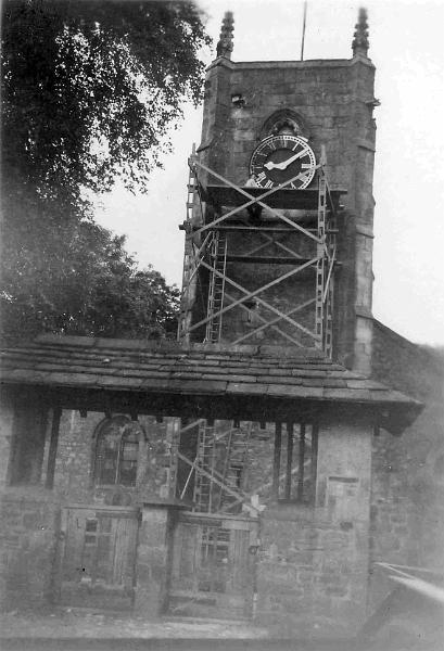 Painting Clock Face.jpg - Joe Parker painting the church clock in June 1951.